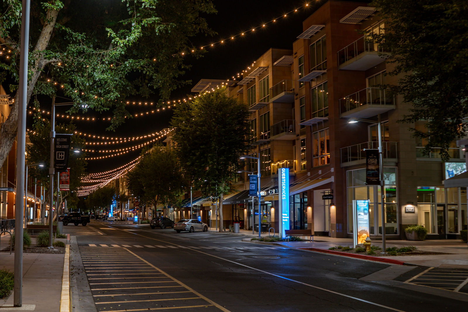 The High Street district at night with string lights over the street