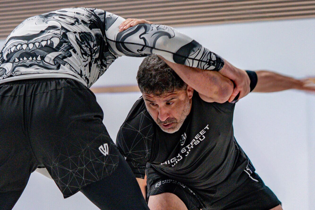 Two wrestlers fight for a collar tie in a no-gi clinch